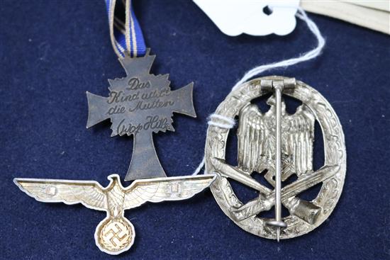 A German Red Cross arm band and paperwork, a Mothers cross and a General Assault badge